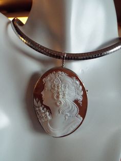 "It is absolutely gorgeous hand carved vintage sardonyx cameo, signed by DG. The piece is 60 mm x 45mm, (2.36 x 1.77\"). It has an enhancer to wear with a chain. omega or pearls. It also has a pin for wearing with your favorite scarf or sweater. It is set in a bezel setting set into 0 925 Italian silver. It comes with a certificate of authenticity and a beautiful black velvet box for gift giving. Item Number 779 Reference 3.09.2019 --- Welcome to CASCO Cameos, LLC. CASCO Cameos is the sole provi Luxury Silver Cameo Jewelry, Box For Gift, Twisted Ribbons, Filigree Pattern, Diamond Settings, Bezel Setting, Item Number, Gold Frame, Black Velvet