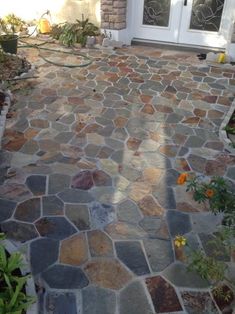 a stone walkway in front of a house