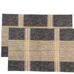 two black and beige rugs on a white background