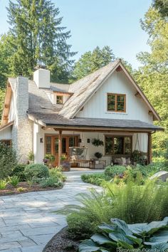 a white house surrounded by greenery and trees