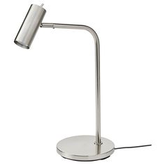 a metal table lamp on a white surface with a cord attached to the base and one light turned on