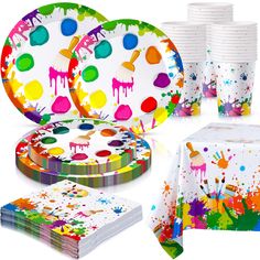 party supplies including paper plates, napkins and cups with paint splattered on them