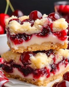 two pieces of cherry cheesecake are stacked on top of each other