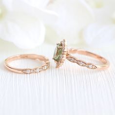 This gracefully sculpted green sapphire ring bridal set features a tiara halo diamond sea foam green sapphire engagement ring and a matching scalloped diamond wedding band to create the distinctive and elegant look. Adore your future bride with this timelessly elegant yet unique sapphire and diamond ring stack. It can be made in your choice of platinum or 18k or 14k yellow, rose, or white gold. ** The hand model's ring size is US ring size 6.25 Jewelry Information Engagement Ring: Center Stone:* Green Stackable Sapphire Ring For Wedding, Half Diamond Wedding Band, Diamond Ring Stack, Halo Diamond Ring Set, Pear Moissanite Engagement Ring, Diamond Alternative Engagement Ring, Halo Ring Setting, Oval Sapphire Ring, Oval Moissanite Ring