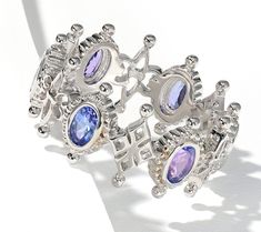 Regal in appearance, this sterling silver band ring is loaded with colorful gemstones. The stunning design adds a touch of elegance to any ensemble, for a wonderful addition to your jewelry collection. From Dallas Prince. Elegant Stackable Rings With Stones, Silver Rings With Stones Fine Jewelry, Fine Jewelry Silver Gemstone Stackable Rings, Silver Rings With Stones In Fine Jewelry Style, Silver Gemstone Stackable Rings Fine Jewelry, Fine Jewelry Silver Rings With Stones, Elegant Multicolor Amethyst Ring With Gemstone Accents, Elegant Silver Multi-stone Stackable Rings, Luxury Silver Sapphire Ring With Gemstone Accents