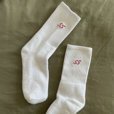 "Details: - Embroidered - 80% cotton, 17% polyester, 3% spandex - Cushioned sole - Machine washable - Made in USA Introducing the Carlos Sainz Embroidered \"55\" Ankle Crew Sock- the perfect subtle expression of your love for all things Carlos x Ferrari x Formula 1." White Sports Socks For Winter, White Sporty Winter Socks, White Sporty Socks For Winter, White Winter Sports Socks, Winter Sports Cotton Socks, White Super Soft Socks, White Super Soft Comfortable Socks, Comfortable Super Soft White Socks, Comfortable White Cotton Socks