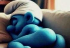 a blue baby sleeping on top of a couch