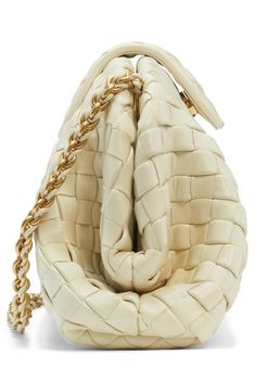 A reimagined version of a 1980 archival design from Bottega Veneta, this clutch is made of supple lambskin leather using their signature intrecciato technique. A drop-in leather-woven chain strap offers an additional carrying option. Magnetic tab closure Drop-in chain-and-leather strap Leather lining Leather Made in Italy Designer Handbags Luxury Cream Shoulder Bag With Woven Leather, Luxury Cream Woven Leather Shoulder Bag, Luxury Cream Shoulder Bag With Intrecciato Weave, Luxury Cream Intrecciato Shoulder Bag, Luxury Clutch With Intrecciato Weave, Designer Woven Leather Clutch, Luxury Evening Clutch With Intrecciato Weave, Luxury Cream Leather Clutch, Woven Chain