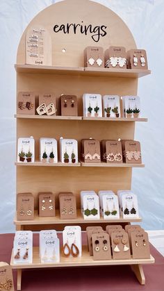 there are many earrings on display in the store, and one is for sale at the end of the shelf