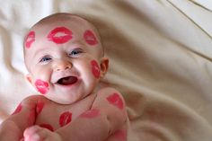 a baby with pink and red lipstick on it's face