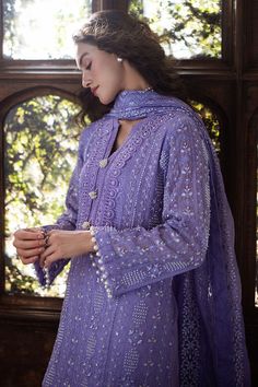 Experience elegance with our exquisitely curated ensemble, featuring a raw silk shalwar and a chikankari embroidered shirt adorned with light sequins, pearl embellishments, and pearl sleeve buttons. The shirt is enhanced with lace insertion on the borders, and the dupatta completes the look with four-sided chikankari borders and pearl hanging tassels. This is a 3 pc outfit. Chikan Suits Designs Pakistani, Designer Chikankari Suits, Kurta Neck Design With Buttons, Pearl Sleeves Design For Kurti, Pearl Lace Design On Suits, Chikan Suits Designs, Pearl Suit Design, Lace Designs On Suits 2024, Elegant Straight Kurta Sharara In Mulmul