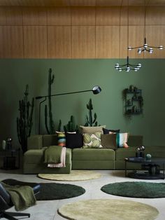 a living room filled with lots of green furniture