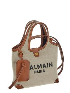 Balmain mini shopping bag in beige canvas with brown leather inserts, contrasting topstitching, logo embroidery, twin top handles, top magnetic closure, inner card slot and slim detachable shoulder strap. Composition: 58%COTTON 42%LINEN | Balmain Women's B-army Grocery Bag in White | SS24 Mini Shopping Bag, Logo Embroidery, Couture Collection, French Design, Grocery Bag, Embroidery Logo, Magnetic Closure, Luxury Boutique, Brown Leather