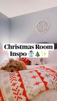 a dog laying on top of a bed in a room with blue walls and christmas decorations