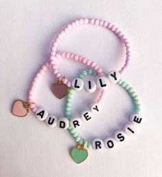 Girls Name Bracelets - Candy Colored The sweetest name bracelet for your little girl. And makes a great gift or baby shower gift ✨ Candy colored 3mm seed beads with personalized name and heart charm Color options available* CARING TIPS FOR YOUR JEWELRY ⭐️Treat and store with care. ⭐️ For longevity, avoid exposing your jewelry to water. ⭐️ Avoid having direct contact with lotions, perfumes, sanitizers as these chemicals may cause discoloration of your jewelry. Personalized Pink Name Bracelet For Party Favors, Cute Beaded Name Bracelet Gift, Cute Beaded Name Bracelet As A Gift, Cute Beaded Name Bracelet As Gift, Cute Heart Beads Beaded Bracelets For Valentine's Day, Cute Heart Beaded Bracelets For Valentine's Day, Cute Beaded Bracelets For Personalized Gifts, Trendy Personalized Heart-shaped Friendship Bracelets, Cute Beaded Name Bracelet As Personalized Gift