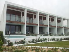 a large white building with balconies on the second floor