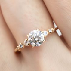 a woman's hand with a diamond ring on it