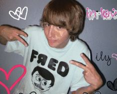 a young man making the peace sign with his hands while wearing a t - shirt that says fried