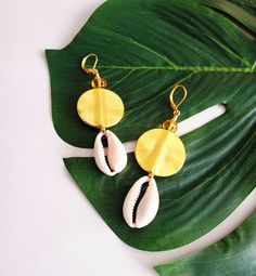 "Cowrie Shell Earrings, Cowry Shell Earrings, Afrocentric Earrings, Ethnic Dangle Earrings The cowrie shell earrings displayed are very stylish with a unique ethnic theme. Shells are wire wrapped with brass, gold plated ear wires, 2.0\" length. *Customer service is of utmost importance to me* Still shopping? Enjoy. www.etsy.com/shop/KheperaAdornments" Etched Copper Jewelry, Jordans Aesthetic, Cowrie Shell Earrings, African Inspired Jewelry, Cowrie Shell Jewelry, Afrocentric Earrings, Shell Jewellery, Diy Designs, Cowry Shell