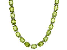 38.40ctw oval green peridot rhodium over sterling silver bolo necklace. Measures approximately 3/16"W. Sliding adjustable clasp. Formal Adjustable Oval Necklace, Formal Adjustable Necklace, Oval Green Peridot Necklaces, Adjustable Elegant Lime Green Jewelry, Classic Peridot Jewelry, Oval Peridot Jewelry For Formal Occasions, Formal Oval Peridot Jewelry, Classic Lime Green Oval Jewelry, Lime Green Gemstone Jewelry For Formal Occasions