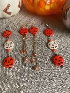 Delicate and sweet orange and white jack o lantern earrings First pair of jack o lantern earrings have dangling gold chains with crystal attached. Triple Orange Jack o lanterns have 2 orange pumpkin charms, and the center pumpkin charm is white! There are also the black tassel pumpkin earrings. These earrings are perfect for Halloween or any other Fall event! **FREE GIFT OF another pair of seasonal earrings from my shop ♥️ Spooky Orange Jewelry Gift, Spooky Orange Jewelry For Gifts, White Dangle Jewelry For Halloween, Orange Dangle Earrings For Halloween, White Jack O Lantern, Halloween Earrings Diy, Halloween Jewelry Diy, Lantern Earrings, Jack O Lanterns