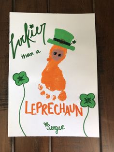 a child's handprint with an orange leprechaun wearing a green hat