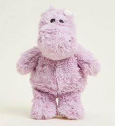 a purple stuffed animal is standing upright