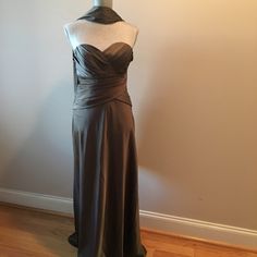 a dress on a mannequin in front of a wall