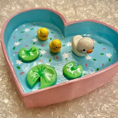 a heart shaped bathtub with rubber ducks in it