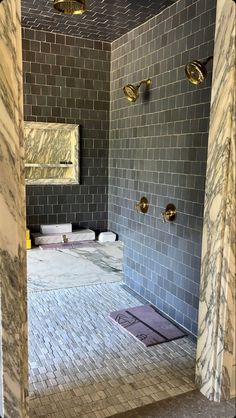 an image of a bathroom setting with marble tiles on the shower wall and tile floor