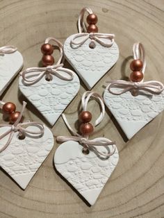 six heart shaped ceramic ornaments on a plate