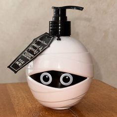 a hand soap dispenser with eyes on it