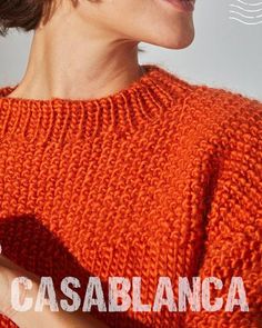 a woman wearing an orange sweater with the words casablanca in front of her