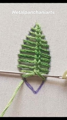 the green thread is being used to make a christmas tree ornament