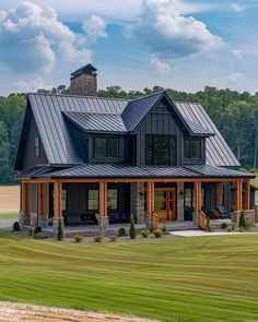 a large house with a metal roof in the middle of a field