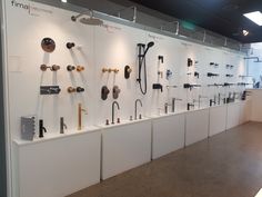 a wall with many different types of items on it in a room that is filled with white walls