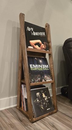 a wooden book shelf with vinyl records on it