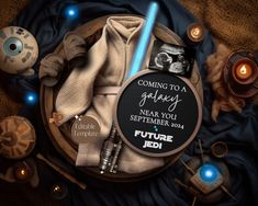 a star wars themed birthday card surrounded by candles and other items on a blanket with the words, coming to a galaxy near you