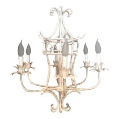 a white chandelier with six lights hanging from it's center and four arms