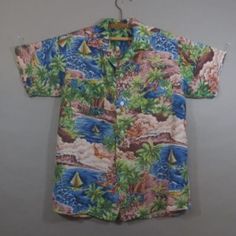 Vintage 1950's HAWAIIAN SHIRT, Silky Rayon, Loop Collar, Two Chest Pockets, Excellent Condition, Sail Boats, Palm Trees, No Label. No size tag or label. Measurements: 16" across top of shoulders 21" across chest underarm to underarm...shirt laying flat 6" sleeves 27" long down mid back Vintage Cotton Camp Shirt For Vacation, Vintage Cotton Hawaiian Shirt For Vacation, Vintage Multicolor Short Sleeve Hawaiian Shirt, Vintage Multicolor Hawaiian Shirt For Summer, Vintage Multicolor Hawaiian Shirt, Vintage Green Camp Shirt For Beach, Vintage Green Camp Shirt For The Beach, Hawaiian Shirt With Vintage Print And Camp Collar, Vintage Hawaiian Shirt With Retro Print For Summer