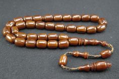 Tesbih Amber Rosary Original Prayerbead Handmade Rosary Kehribar Tesbih Beads Amber Tesbih Misbaha Islamic Prayer Beads Tasbih Tespih Prayer beads with 33 beads Bead size: 8.5 x 11.5 mm The rosary is completely handmade and a work of mastery. It has a perfectly processed and durable hand-knitted rope tassel. PRICE INCLUDES SHIPPING Please note: We offer the item in a variety. Variations in the size of the imams or beads are possible. Color deviations are also possible Note: Amber can change colo Traditional Brown Rosary With Round Beads, Traditional Adjustable Rosary With Polished Beads, Traditional Beaded Brown Rosary, Traditional Brown Beaded Rosary, Traditional Brown Beads For Gift, Traditional Brown Beads For Gifts, Traditional Handmade Brown Rosary, Traditional Handmade Rosary, Traditional Adjustable Brown Rosary