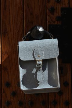 Lifestyle Image of light grey leather crossbody bag with top handle - The Binocular Bag in French Grey Celtic Grain from The Cambridge Satchel Co. Womens Handbag, Summer Adventures