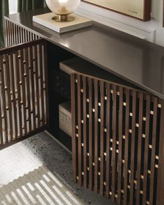 a room with a large mirror and a wooden cabinet next to a rug on the floor