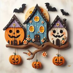 an image of halloween decorations hanging on the wall with bats and pumpkins around them