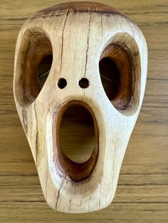 a wooden mask with holes in the middle