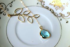 "READY TO SHIP! Aquamarine Lariat Necklace Aqua Blue Lariat Leaf Gold Necklace - Bridal Necklace - Bridesmaid Lariat Necklace - Bridesmaid Jewelry Wedding The aquamarine gem is 13mm with 5mm thickness at the widest part. It is 14k gold plated. The chain is 14k gold filled and measures 2mm X 1.4mm. It is a flat cable design. The length of this particular necklace is approximately 16.5 inches. The leaf measures 18mm x 39mm. If you need a different length, no problem! Please just let me know when y Elegant Blue Lariat Necklace Gift, Elegant Blue Lariat Necklace With Adjustable Chain, Gold Necklace Bridal, Aquamarine Gem, Jewelry Wedding, Lariat Necklace, Bridal Necklace, Bridesmaid Jewelry, Aqua Blue