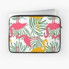 a laptop case with pink flamingos and palm leaves on it, sitting on a white surface