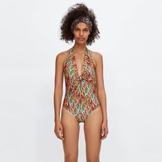 New Without Tags, Never Worn, In Perfect Condition. Printed Swimsuit Featuring A Plunging Neckline, Halter Neck And Tie Closure In The Back. Contrasting Interior Lining. - Exterior: 82% Polyamide, 18% Elastane; Lining: 86% Polyester, 14% Elastane -- Multicolor Halter Neck Bodysuit For Vacation, Multicolor Halter Neck Bodysuit For Poolside, Orange V-neck Swimwear For The Pool, Orange V-neck Swimwear For Pool, Orange Beachwear Bodysuit For Beach Season, Orange One-piece Bodysuit For Beach, Orange One-piece Bodysuit For Beach Season, Zara Summer Beach Bodysuit, Zara Summer Bodysuit For Beach