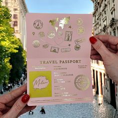 two hands holding up a pink travel passport