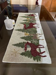 the table is decorated with christmas trees and deers